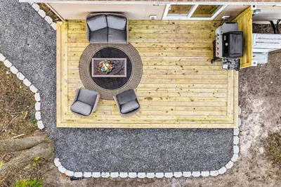 an overhead view of a patio with two chairs and a tv at Pond Haven Retreat Wood-Burning HotTub & FirePit in Mount Bethel