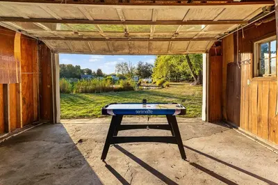 a ping pong table sitting inside of a house at Pond Haven Retreat Wood-Burning HotTub & FirePit in Mount Bethel