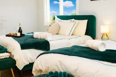 two beds sitting next to each other in a room at Modern Lakeview Escape | Scenic Deck • Fire Pit in Monroe