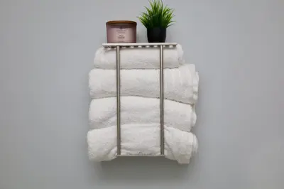 a metal towel rack with towels and a plant at Modern Lakeview Escape | Scenic Deck • Fire Pit in Monroe