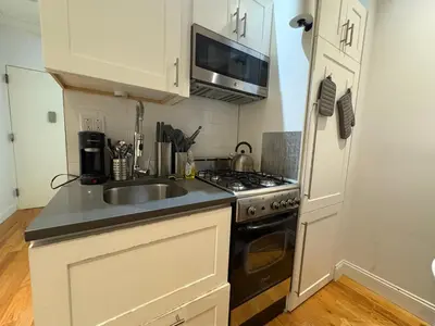 a kitchen with a sink and a stove at Signature by Times Square in New York
