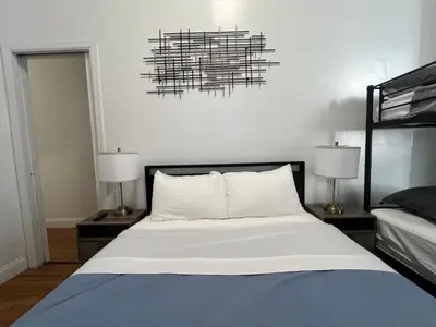 a bedroom with a bed with two night stands and two lamps at Parkline Suites Upper West Side in New York