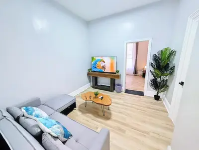 a living room with a couch and a table at PATHside 1BR Quick Access to NYC in Hoboken