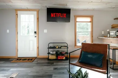 a living room with a exit sign on the wall at Mural Art Cabin With Pond And Hot Tub in Narrowsburg