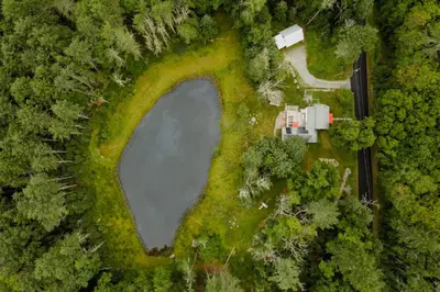 an aerial view of a lake in a forest at Waterfront 1900s Hot Tub Eldred Homestead in Eldred