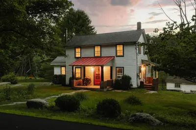 a small house with a red awning on it at Waterfront 1900s Hot Tub Eldred Homestead in Eldred