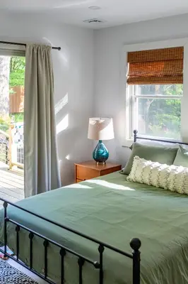 a bedroom with a bed and a window at Hare & Hollow with Hot Tub & Fenced Yard