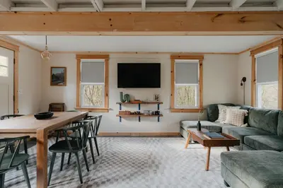 a living room with a couch and a table at 1930's Vintage Cabin Hot Tub Kohler Cabin in Jeffersonville