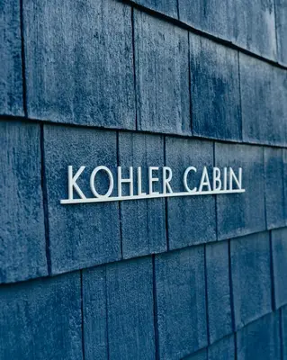 a sign on the side of a building at 1930's Vintage Cabin Hot Tub Kohler Cabin in Jeffersonville