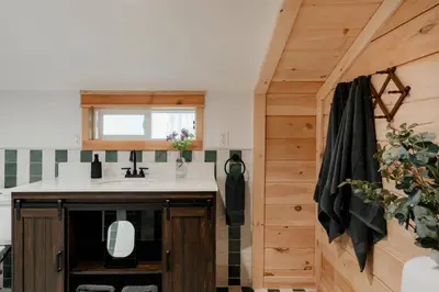 a kitchen with a sink and a window at 1930's Vintage Cabin Hot Tub Kohler Cabin in Jeffersonville