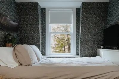 a bedroom with a bed and a window at Rivers Ledge Cabin with Sauna and Hot Tub in Barryville