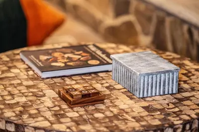 a table with a book and a box on it at Rivers Ledge Cabin with Sauna and Hot Tub in Barryville