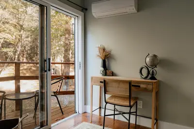 a room with a desk and chairs and a window at Rivers Ledge Cabin with Sauna and Hot Tub in Barryville