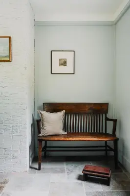a wooden bench in a room with a pillow on it at Roebling House 1850s Cabin Hot Tub Fire Pit in Barryville