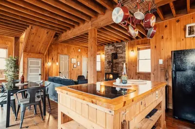 a kitchen and living room with a large island at Breathtaking River Views The Hawks Nest Cabin in Glen Spey