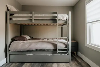 a bunk bed in a bedroom with a bunk bedutenewayeway at Swan Pond Cabin Hot Tub & Firepit Retreat in Swan Lake