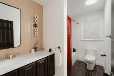 a bathroom with a sink and a toilet and a mirror at Woods Edge Private 5 Acres Hot Tub Fire Pit in Barryville