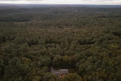an aerial view of a house in the middle of a forest at Woods Edge Private 5 Acres Hot Tub Fire Pit in Barryville