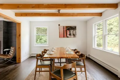 a dining room with a wooden table and chairs at Woods Edge Private 5 Acres Hot Tub Fire Pit in Barryville