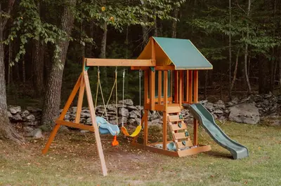 a playground with a swing and a slide at Woods Edge Private 5 Acres Hot Tub Fire Pit in Barryville