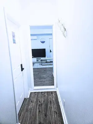 a hallway with a door leading to a kitchen at Home away from home 5 minutes away EWR Airport in Elizabeth