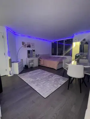 a bedroom with a bed and a table and chairs at LOFT IN WITH ALL AMENETIES BUILDING BEST LOCATION IN MIDTOWn in New York