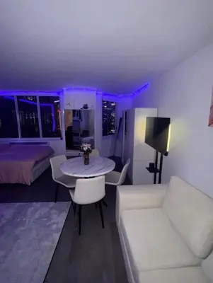 a living room with a couch and a table and a bed at LOFT IN WITH ALL AMENETIES BUILDING BEST LOCATION IN MIDTOWn in New York