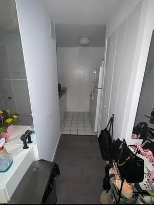 a small white bathroom with a sink and a refrigerator at LOFT IN WITH ALL AMENETIES BUILDING BEST LOCATION IN MIDTOWn in New York