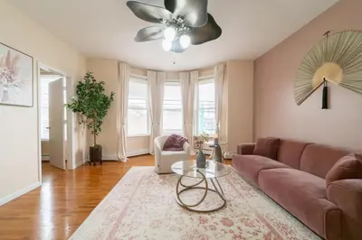 a living room with a couch and a ceiling fan at The Boulevard Stay! 25 mins to NYC! Spacious 2BR! in Harrison