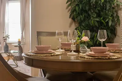 a dining room table with glasses and plates on it at The Boulevard Stay! 25 mins to NYC! Spacious 2BR! in Harrison