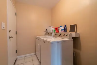 a small laundry room with a washer and dryer at The Boulevard Stay! 25 mins to NYC! Spacious 2BR! in Harrison