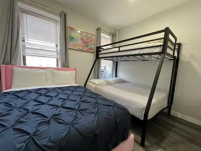 a bedroom with two bunk beds and a bed at VibeHaus Midtown in New York