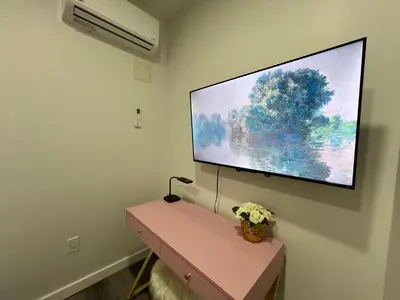 a flat screen tv hanging on a wall at VibeHaus Midtown in New York