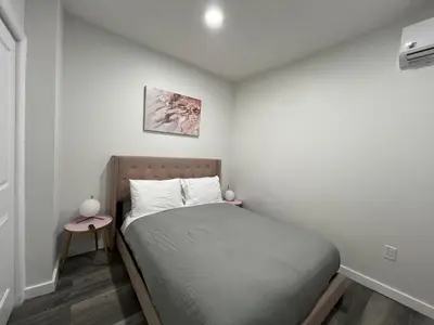 a small bedroom with a bed in a room at VibeHaus Midtown in New York