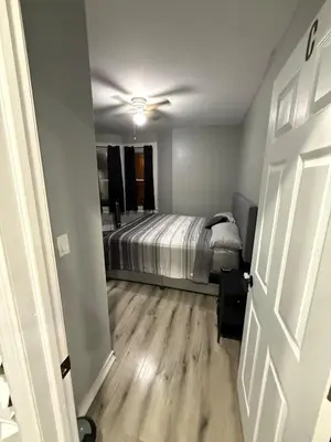 a bedroom with a bed and a ceiling fan at EWRBNB - Rare Find! Huge 3BR Apartment with Open Layout minutes from Newark Airport & NYC - Apartment # 1 in Elizabeth