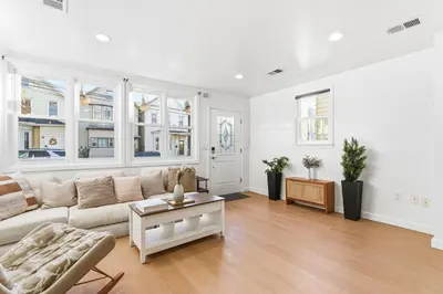 a living room with a couch and a table at Hamilton-15 mins to EWR, 20 mins PATH to NYC in Harrison