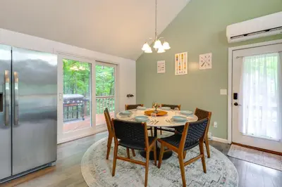 a dining room with a table and a refrigerator at 1 Mi to Lake, Golf and Ski Access The Hideout Home! in Arlington