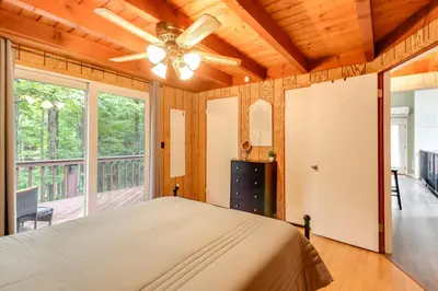 a bedroom with a bed and a large window at 1 Mi to Lake, Golf and Ski Access The Hideout Home! in Arlington