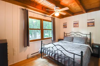 a bedroom with a bed and a ceiling fan at 1 Mi to Lake, Golf and Ski Access The Hideout Home! in Arlington