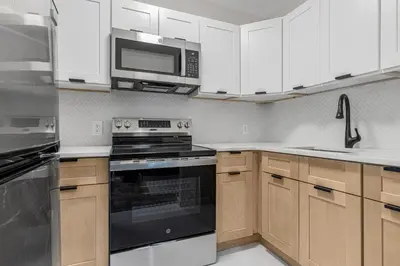 a kitchen with a stove and a microwave at Time Square Apartment in New York