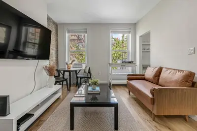 a living room with a couch and a table at Time Square Apartment in New York