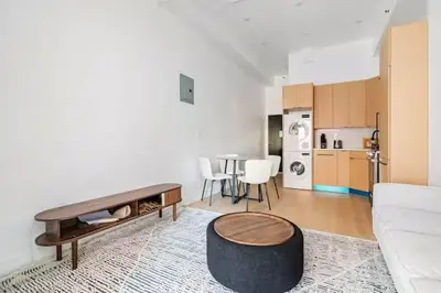 a living room with a couch and a table at 19-4I Stylish 1BR in the Heart of the East Village in New York