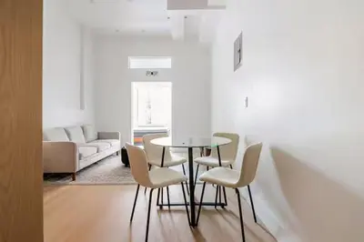 a living room with a table and chairs and a couch at 19-4I Stylish 1BR in the Heart of the East Village in New York