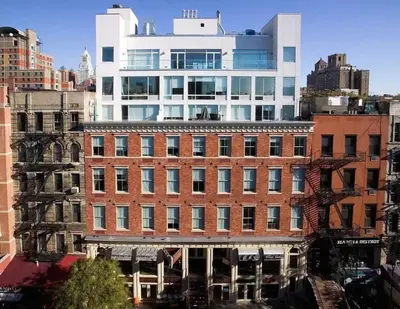 a large brick building in a city with tall buildings at 19-4I Stylish 1BR in the Heart of the East Village in New York