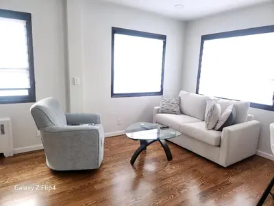 a living room with a couch and a chair and a table at Modern & Tranquil Apartment in Bogota