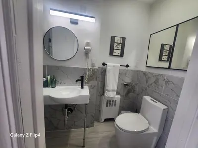 a bathroom with a sink and a toilet and a mirror at Modern & Tranquil Apartment in Bogota