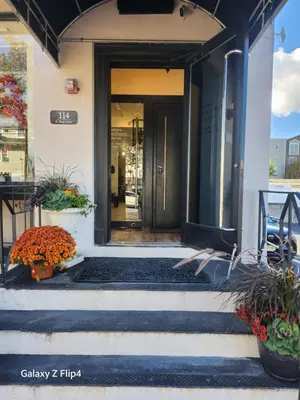 a front door of a building with plants on the steps at Modern & Tranquil Apartment in Bogota