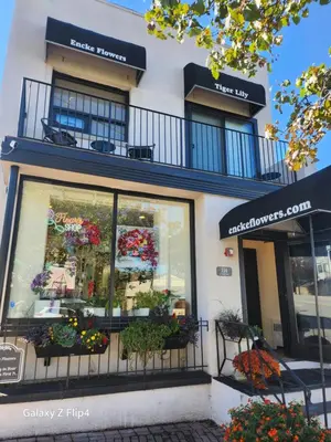 a store with flowers in the windows of a building at Modern & Tranquil Apartment in Bogota
