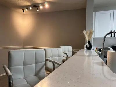 a conference room with a table and white chairs at A private master room in modern complex shared apartment in Lawrenceville