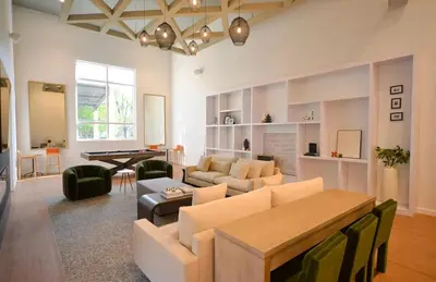 a living room with a couch and a table at A private master room in modern complex shared apartment in Lawrenceville